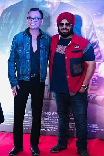 Snehaashish Pathakk, in a denim jacket and glasses, with Sikandar Maan, in a red jacket and red turban, on the red carpet at the ATHRU launch in Mumbai.